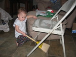 Bella with the little broom we had to get out after the Coke bottle Santa Gail gave me took a tumble off of the end table