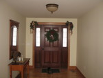Entry hall decorated for Christmas (and Mittens walking into the picture for good measure)