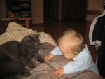 Brianna has learned to cruise along furniture! Ninwa is alarmed.