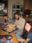Connor, Don, and Kailyn building this year's gingerbread house