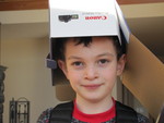 Connor trying on the camera box as a helmet