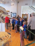 Kids listening while a museum curator explains the exhibits