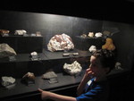 In addition to all of the dinosaur exhibit items, they had a display of minerals upstairs that all of the kids really loved -- especially the part where they turned off the lights and got to see them under black light!  Connor with a mineral case