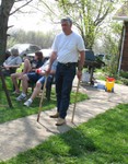 Dad pretending to use some very short sticks as crutches