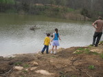 The kids down by Jimmy's pond, trying to find tadpoles