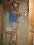 Using a scraping-brush machine to smooth the walls