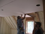 Hanging drywall in Kailyn's room while insulation spraying continues downstairs