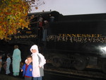 Standing on a bench with the engine behind them
