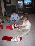 Grandma explained that Santa had dropped off the things for their stockings and asked her to put them in them that afternoon, since he knew the kids would only be there until after dinner.  They were a bit surprised, but they believed her!