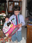 Kailyn (wearing the scarf from her stocking) opens a charm-bracelet-making kit from Grandma and Grandpa