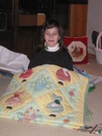 The baskets of flowers are both quilted and painted, and each little girl has lace pantaloons