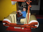 Connor driving a Flintstones car