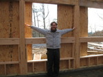 Don demonstrating window width (to the inside of the framing openings -- the plywood is just for extra shelter, not an indicator of window openings)