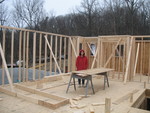Dina standing in her Kitchen.  The flat board on the saw horses is the same size and position as the kitchen island.  The 2x6's on-edge show the counters.  The 2x4's on end show posts.