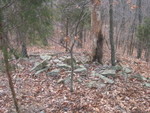 Right on the top of the knoll, which is very steep, there are two big piles of large rocks which were obviously carried there.  Who carried them, and why? We have no idea.