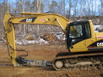 I think this is called a trackhoe. It carves our driveway out of the solid rock.