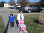Kids taking a doll for a morning stroll
