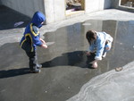 The kids were excited about the puddle of water/ice