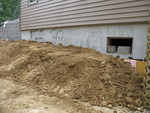 Jacob moved some dirt in to start the grading for this wall