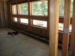 Bench begun under downstairs windows. Don interrupted in time to remind the guys that the whole point of the bench was to insulate that wall -- so they'll leave it at this stage until insulation is in, then build the rest over the insulation