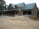 Stonework coming along on the front of the porch