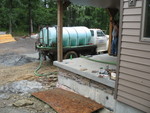 Water truck adding water to the other side of the cistern to equalize pressure