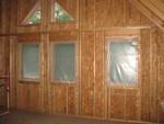 Insulation crew started putting plastic over windows in the early afternoon