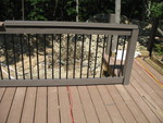 This just looks better, we think, though it isn't what we had initially had in mind -- the use of the trim for the posts and horizontal boards was a makeshift solution when we found that a railing system matching the decking wasn't available!  But I really like the way it looks like this.
