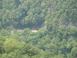 Train tracks disappearing into a tunnel in the side of the mountain