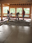 Guys spreading concrete in the kitchen