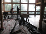 Spreading concrete in the living room. Notice the clouds of smoke outside -- we had a fire barrel going, and then a sudden downpour came along, and the smoke was so thick it was almost surreal.