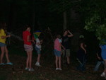 Building a teepee shelter. Kailyn is wearing her umbrella hat just for fun -- it wasn't raining.