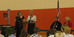 Receiving classroom awards.  She really racked up, getting certificates for math, science, social studies, spelling, and English, plus a poetry contest award and a certificate for being on the honor roll every time all year, and a very fancy certificate accompanied by a letter from President Obama for winning the President's Education Award.