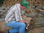 Turning the bee log into a log hive: Billy, Jimmy's dad, smoking the bees before we start