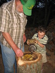 Connor helping smoke the bees before adding the super on top