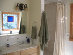 Countertop/shower area, with the window reflected in the mirror. The mirror still needs its frame added.