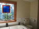 Window and toilet area.  Notice the basket added to the back of the toilet to hold spare paper.