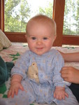 Connor helping Brianna sit up to have her picture taken