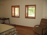 South wall of the guest room.  The table in the far corner is only there temporarily, until we get it fixed and can put it out near the bookcases.