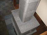 Capstones reinstalled -- now with a square opening instead of the round we had before, when we just had the stovepipe