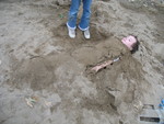 Connor starting to come up out of the sand pretending to be a zombie
