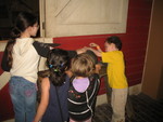Kids trying out the sharpening wheel in The Streets of Old Milwaukee exhibit