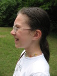Side view showing the droplets on her hair and face