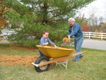 Grandpa adds more needles while Connor spreads them out evenly