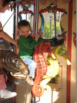 Connor getting ready to ride seahorses on the carousel