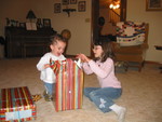 Kailyn *really* wanted to help him open them!

The quilt on the chair in the background was mom's Christmas gift from Grandma Mary.