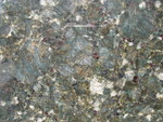 Detail of Verde Butterfly slab: lots of white, gold, different shades of green, and little garnet-like inclusions