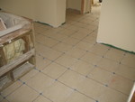 From another angle. The pinkish clouding in some places isn't part of the tile, but the marking chalk they used to help lay it out.