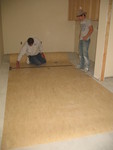 Utility room linoleum installation in progress