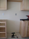 2 complications here: one, they forgot to wire for the microwave/range hood, and two, there's an outlet right behind where my stove goes.  I don't think the stove will be tall enough to cover it, and it's not a practical place for an outlet.